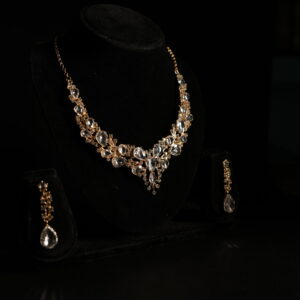 Luxury crystal bridal necklace set with teardrop stones and matching drop earrings in gold-tone finish