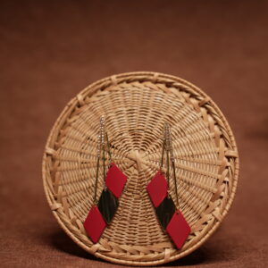 Red and green diamond shape layered drop earrings with long gold crystal chain tassel, displayed on a round wicker basket with warm brown background