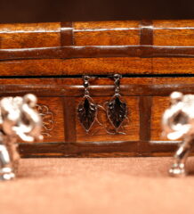 Silver filigree leaf drop earrings with black onyx stone centre displayed on wooden jewellery box – D2Dazzle fashion jewellery India