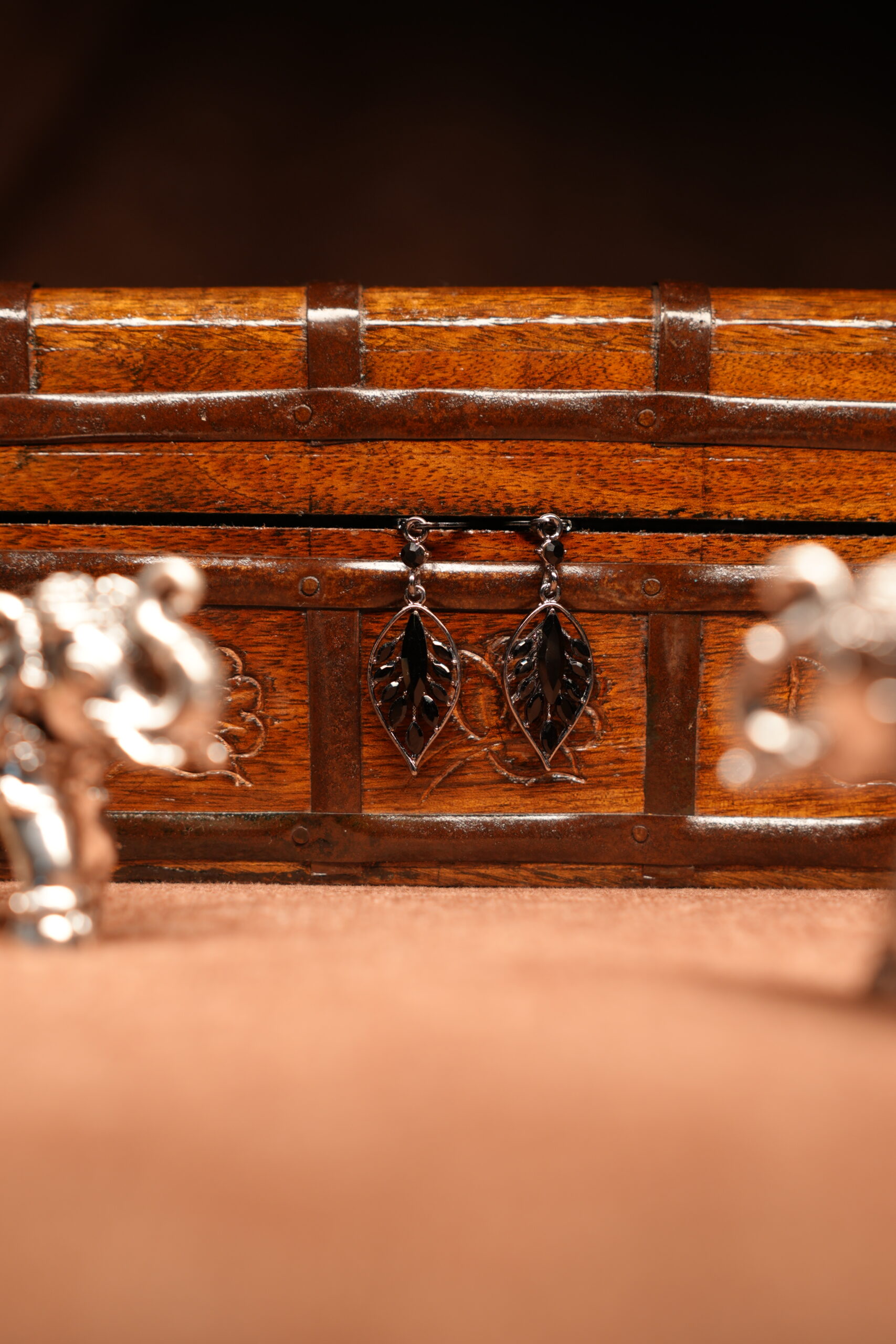 Silver filigree leaf drop earrings with black onyx stone centre displayed on wooden jewellery box – D2Dazzle fashion jewellery India