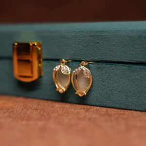 Gold tulip hook drop earrings with opalescent moonstone cabochon and crystal petal crown displayed on teal velvet jewellery box – D2Dazzle fashion jewellery India