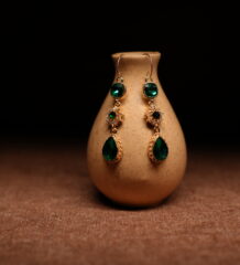 Emerald green crystal teardrop drop earrings with gold starburst connector — D2Dazzle