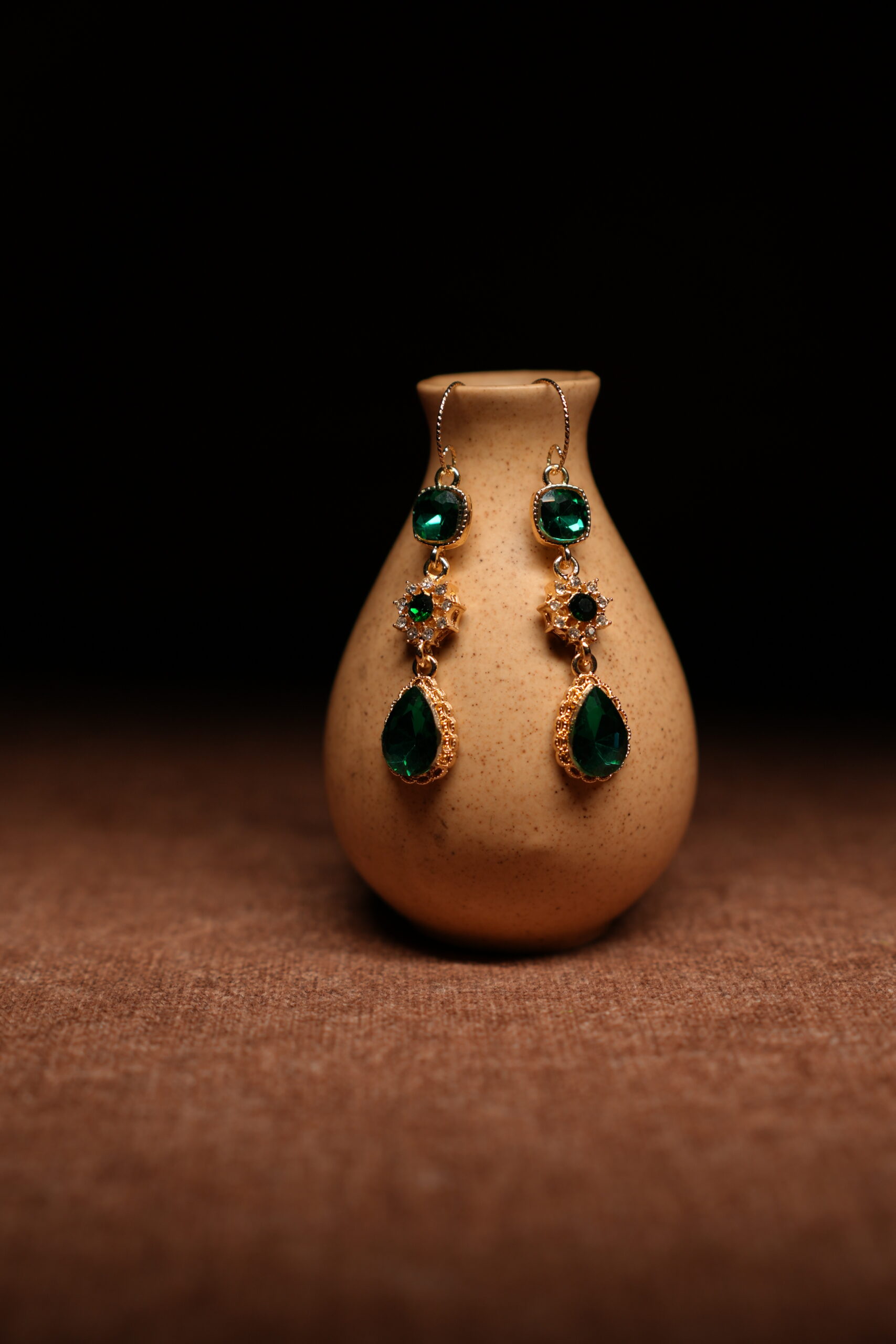 Emerald green crystal teardrop drop earrings with gold starburst connector — D2Dazzle