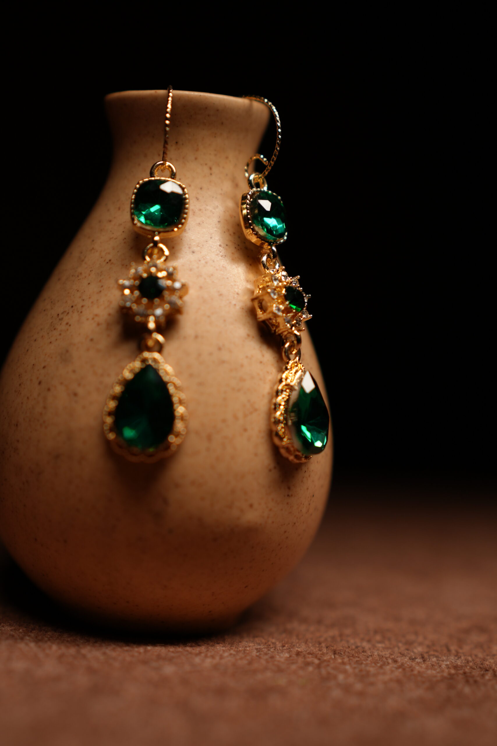 Emerald green crystal teardrop drop earrings with gold starburst connector — D2Dazzle