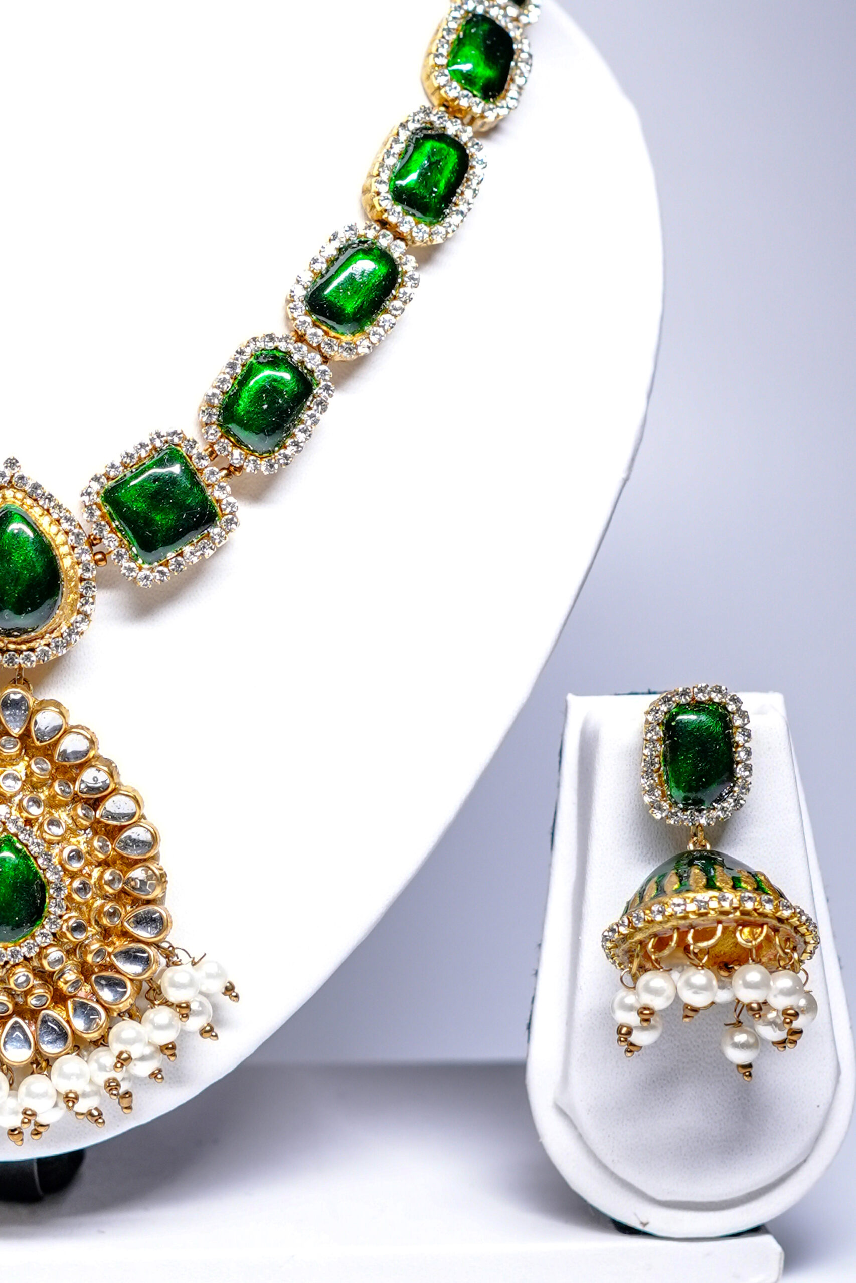 Gold plated kundan necklace set with green stones and pearl-fringed pendant
