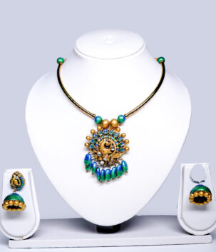 peacock choker necklace with blue-green enamel drops and matching jhumka earrings displayed on a white jewellery bust.