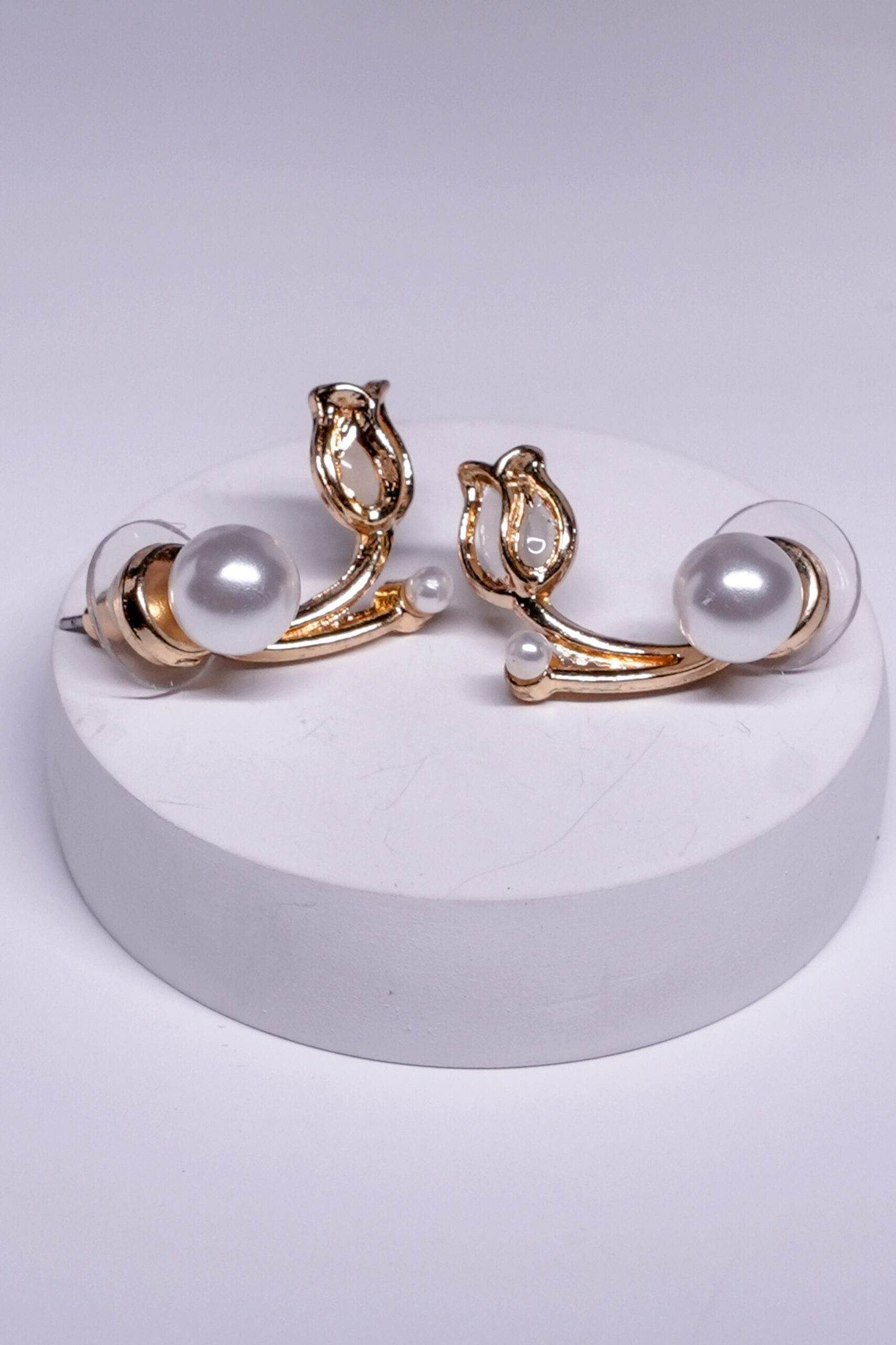 Close-up view of pearl leaf stud earrings showing leaf motif and pearl accent detailing.