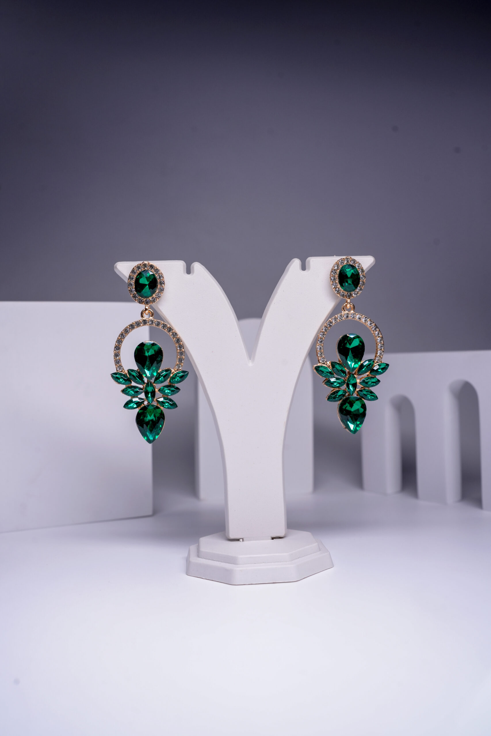 Gold plated emerald crystal floral drop earrings with sparkling halo detailing, displayed on a white jewellery stand. Act as an SEO expert for D2Dazzle, a fashion jewellery WooCommerce store. Based on the attached product image, give me complete Yoast SEO info: Product Title Focus Keyphrase 3-4 Related Keyphrases SEO Title (under 60 characters) Slug/URL Meta Description (under 160 characters) Product Tags (8-10, comma-separated) Category suggestions Main Image Alt Text Gallery Image Alt Text A 300+ word product description with the focus keyphrase used naturally 2-3 times, short sentences, and transition words so it passes Yoast readability