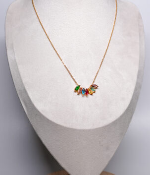 Multicolour marquise-cut zircon cluster pendant necklace in green, pink, blue, red and yellow on a fine cable chain, displayed on a beige velvet bust.
