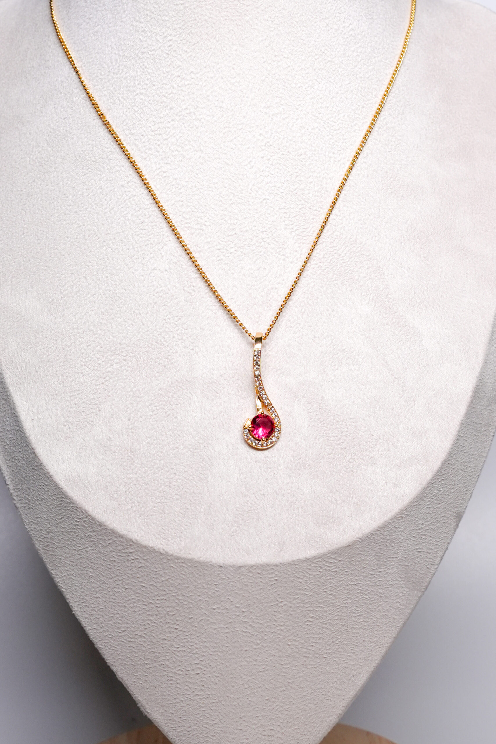 Close-up of the ruby-red round zircon and white zircon curve from D2Dazzle