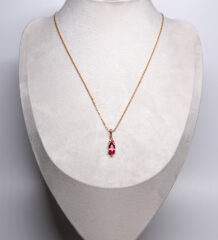 Ruby Pink Zircon Pendant Necklace with a marquise-cut ruby-pink zircon accents on a fine chain, displayed on a grey bust stand.
